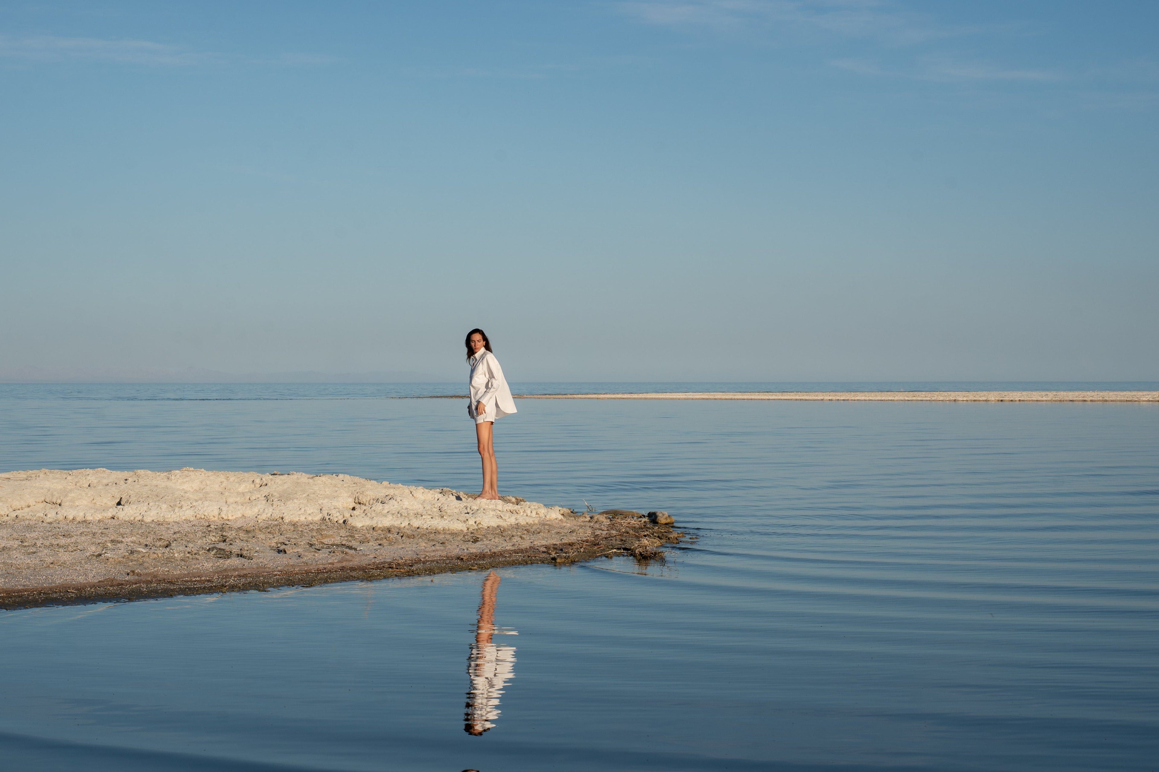 Hctr model standing at lake with optic white button down