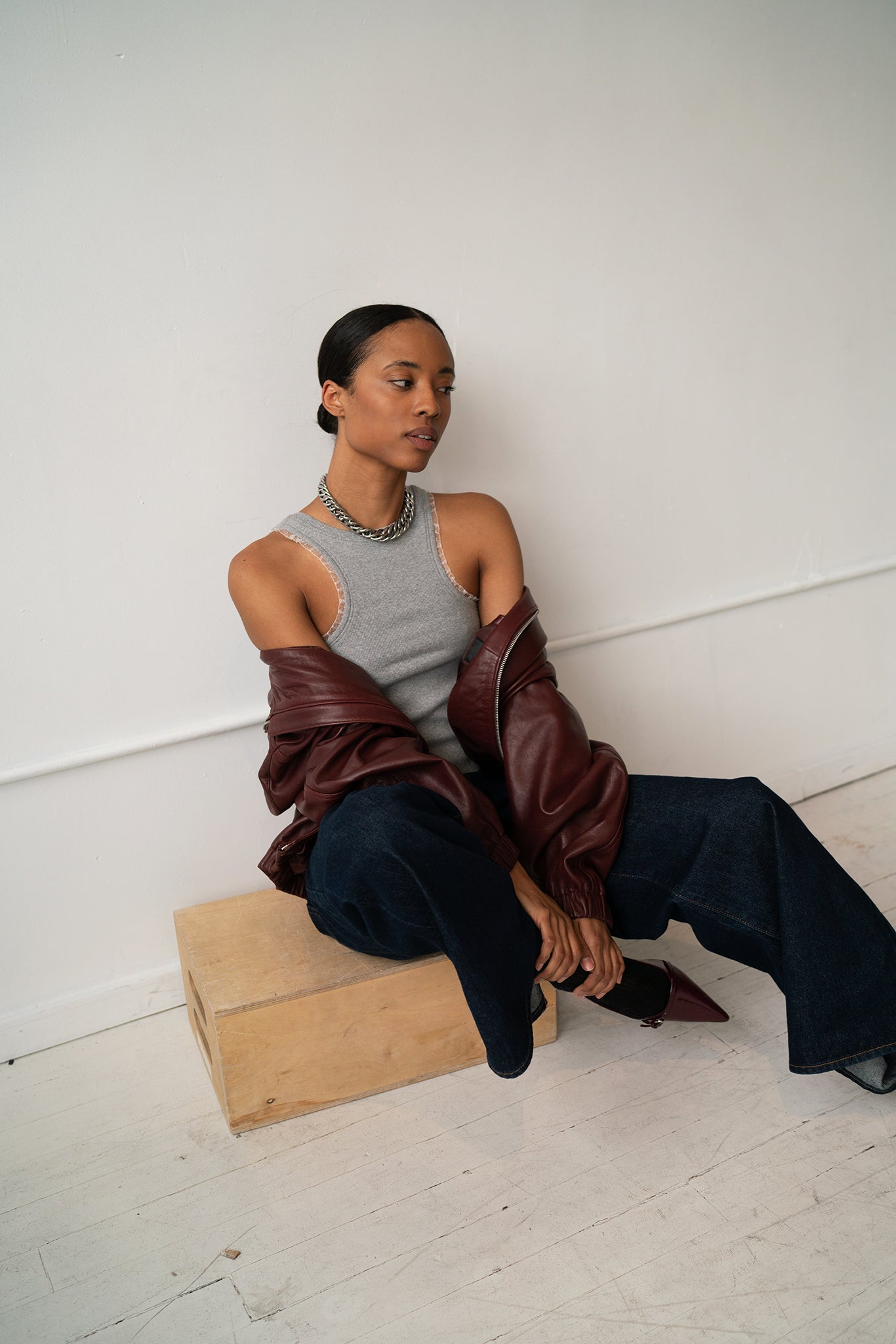HCTR Dual-Neckline Reversible Ribbed Tank in Grey styled with silver chain necklace and oxblood leather jacket, editorial