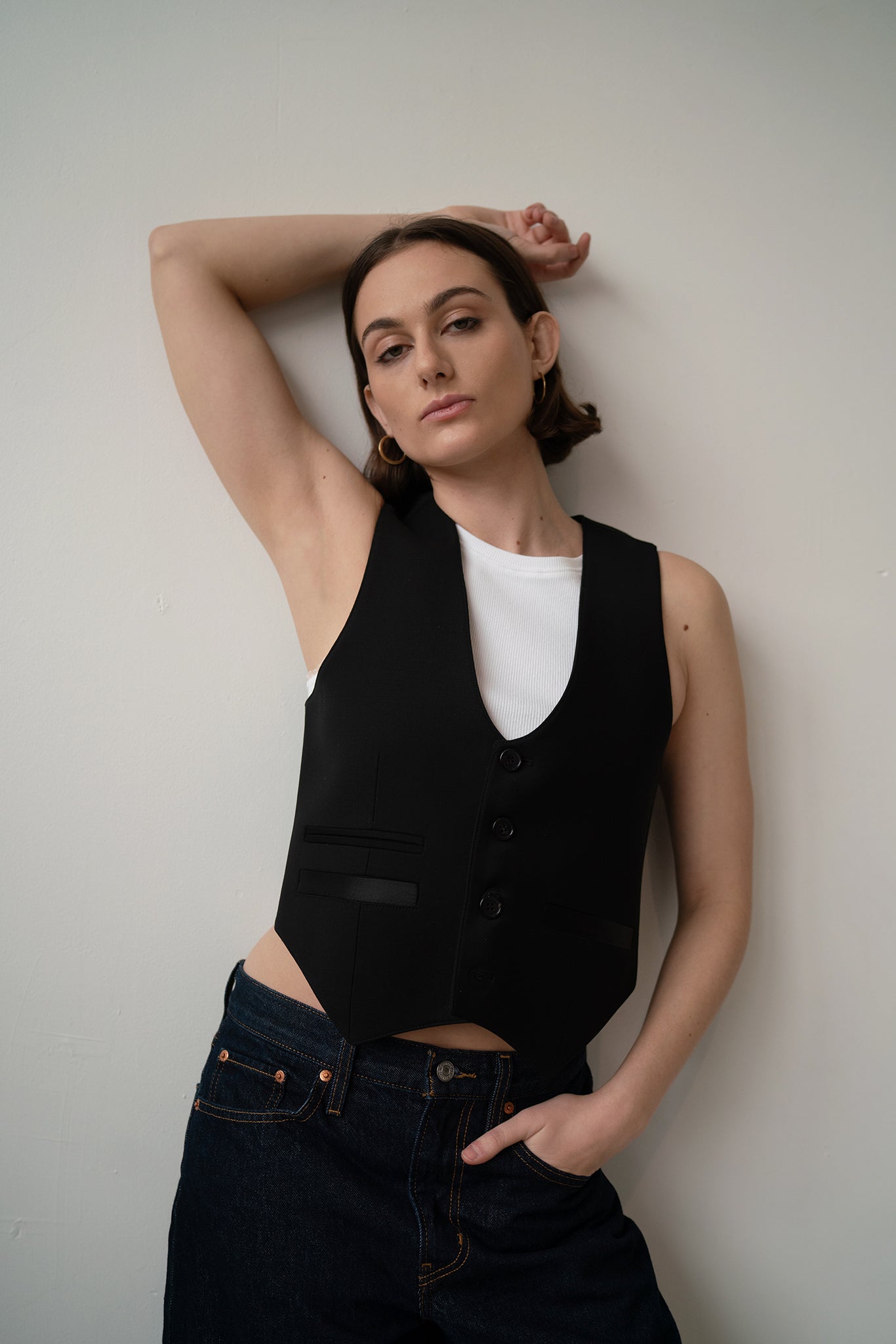 HCTR Modular 100% Wool Waistcoat in Onyx — front view showing structured deep-V silhouette, styled with dark straight-leg jeans and white tank top.