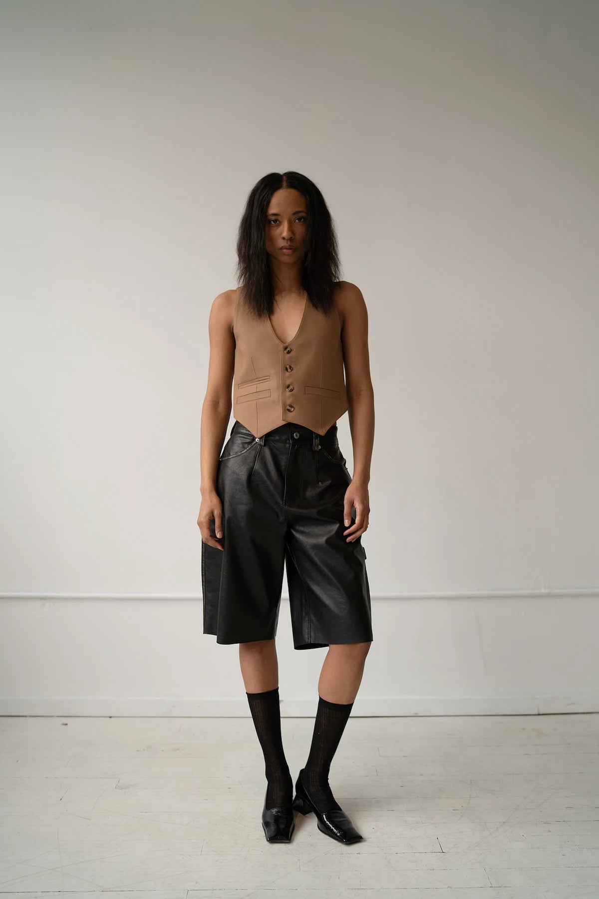 HCTR Modular 100% Wool Waistcoat in Saddle Brown — full front view styled with black leather wide-leg shorts, high socks and low heel.

